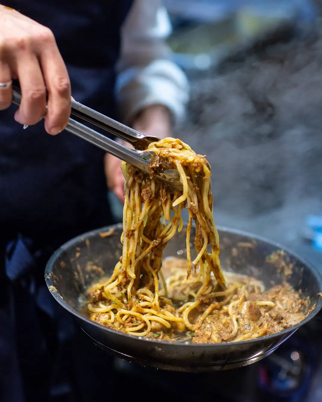 Pasta being finished in the pan