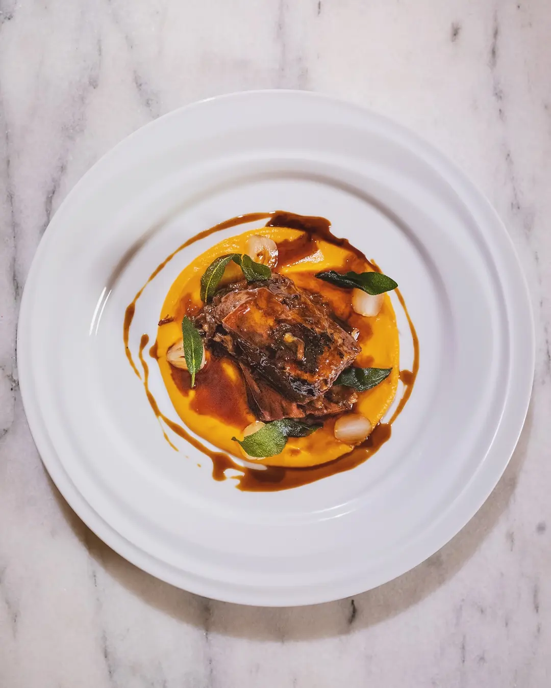 Slow cooked meat on orange puree