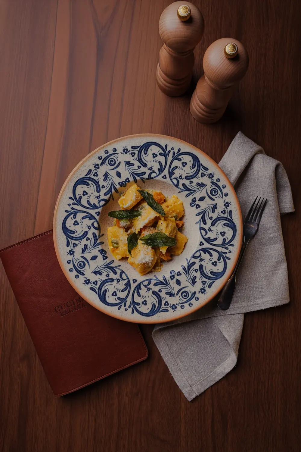 Pasta on a blue patterned plate at Cucina Regina